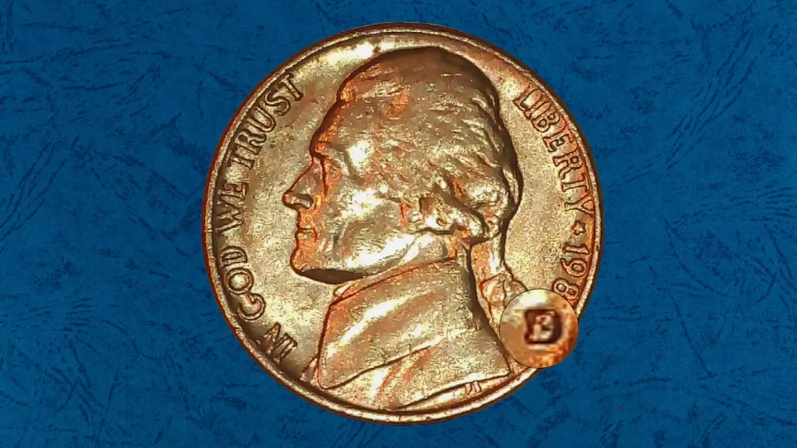 Close-up of the D mint mark on a 1983-D Jefferson nickel showing a repunched mint mark with a secondary D impression offset from the primary